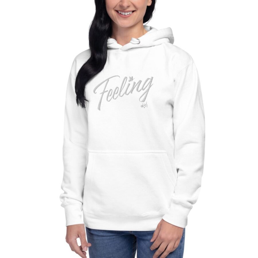 A woman wearing a white Feeling Love Valentine Embroidery Unisex Hoodie with the word falling on it.