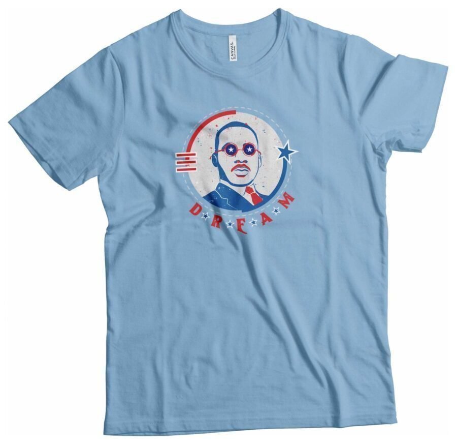 A light blue t-shirt with an image of a man wearing glasses and the keyword "Independence Day 4th July "DREAM"  Luther Unisex Heavy Cotton Tee".