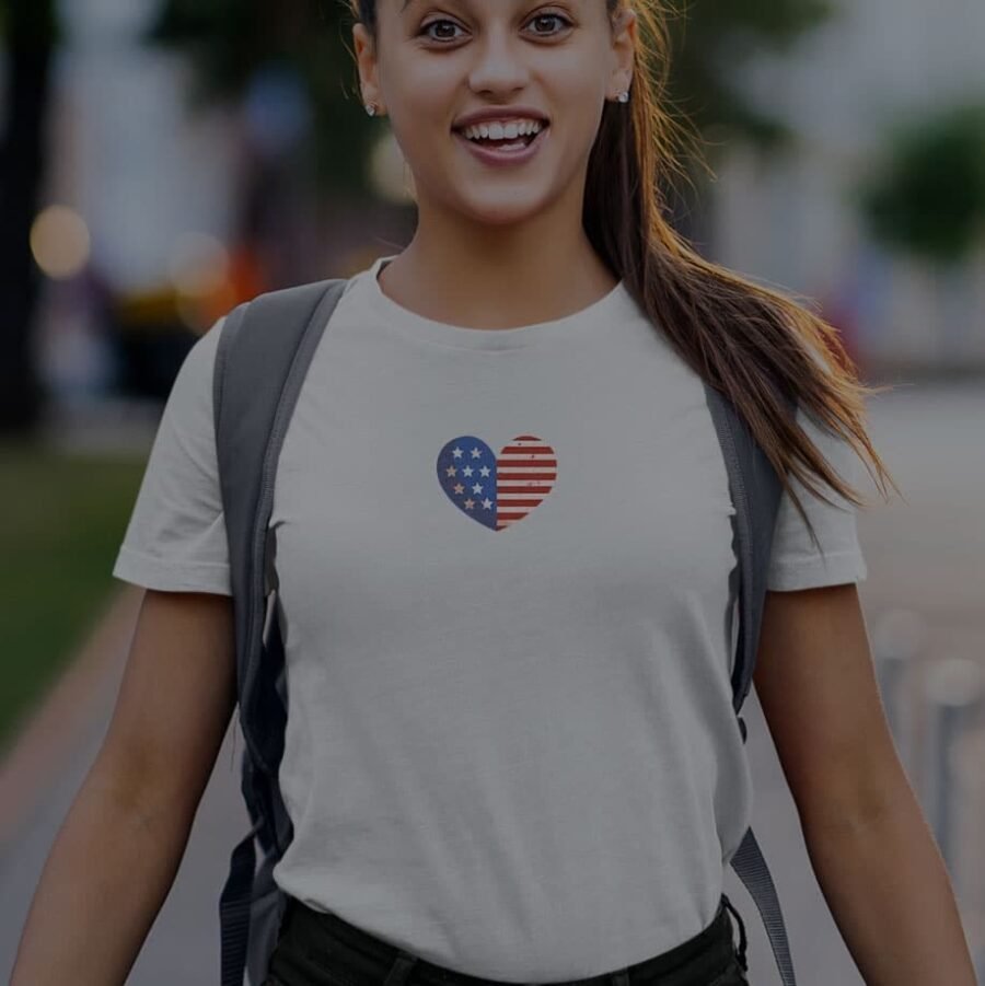 A woman wearing an Independence Day 4th July "HEART" Unisex Heavy Cotton Tee.