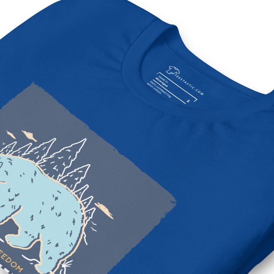 A blue t-shirt showcasing THE SPIRIT OF FREEDOM ALASKA with an image of a bear in the Alaskan forest.