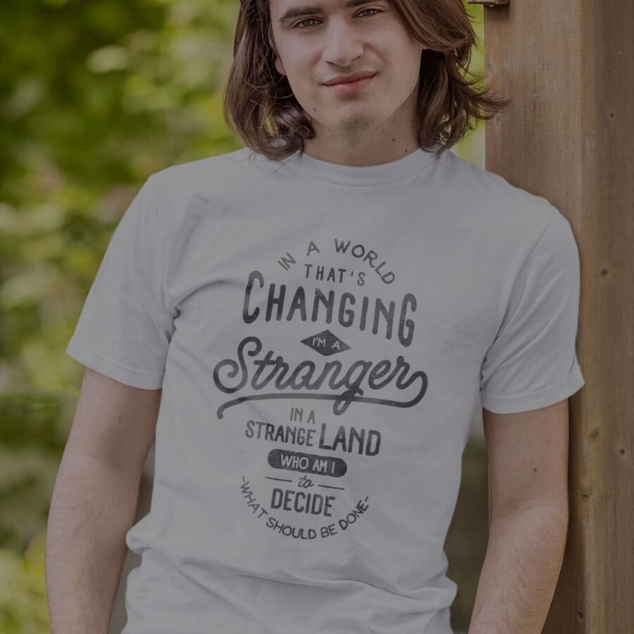 A young man wearing an "In The World Thats Changing Unisex T-Shirt".