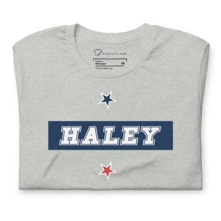 A grey Nikki Haley | Elections 2024 | Unisex Heavy Cotton Tee with the word Haley written on it.