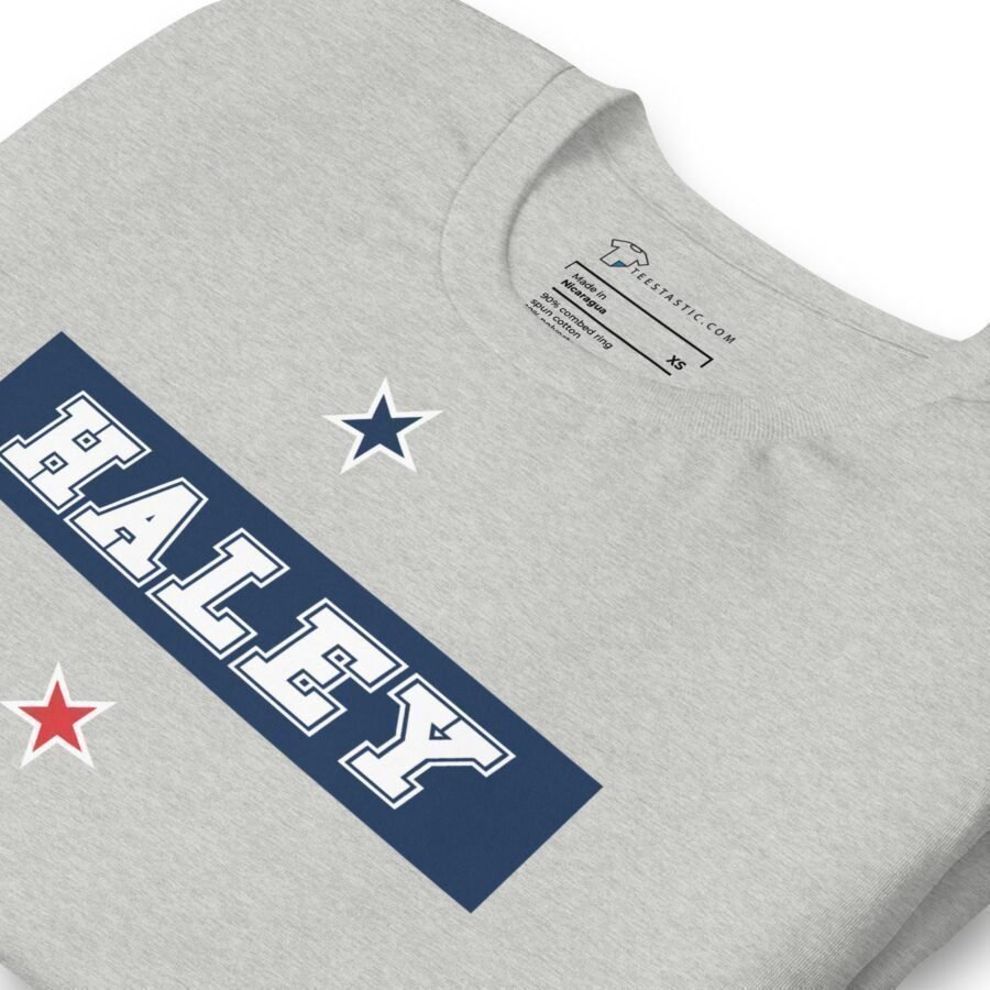 A grey sweatshirt with the Nikki Haley | Elections 2024 | Unisex Heavy Cotton Tee on it.