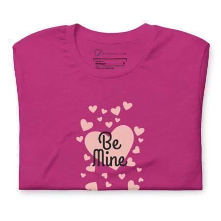 A pink Be Mine t-shirt with hearts and words on it, perfect for expressing love with the "Be Mine" message.