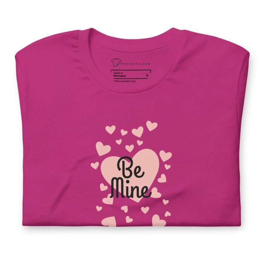 A pink Be Mine t-shirt with hearts and words on it, perfect for expressing love with the "Be Mine" message.