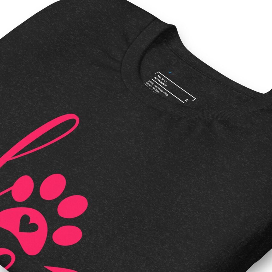 A pink paw print is printed on the front of a black Love My Dog unisex heavy cotton t-shirt, perfect for dog lovers who want to showcase their love for their furry friend.