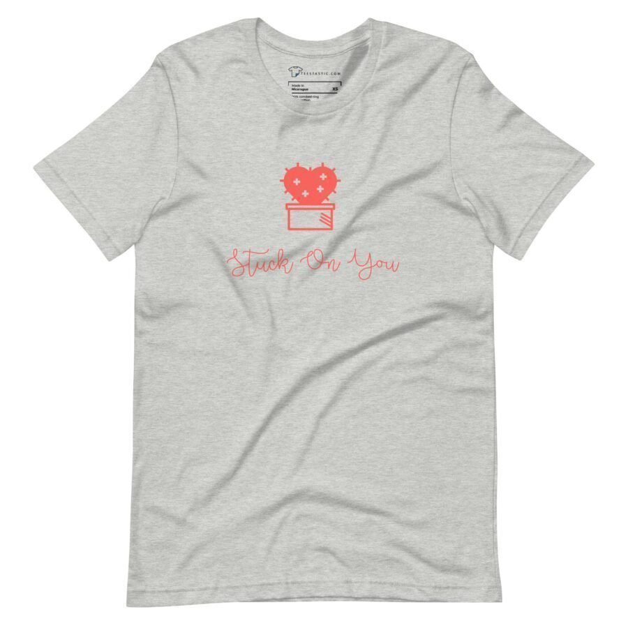 A Stuck On You | Unisex Heavy Cotton gray t-shirt with a red heart stuck on it.