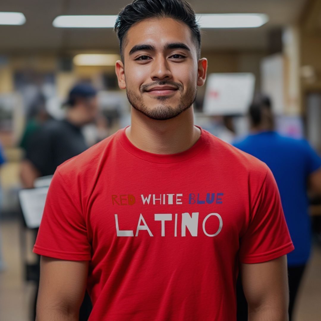 A man wearing a "Hispanic And Proud to Vote Red | Elections 2024" unisex T-shirt stands in an indoor environment with blurred people in the background, subtly hinting at the upcoming Elections 2024.