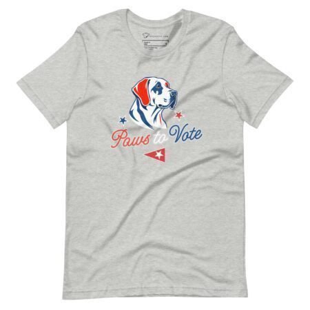 The "Paws to Vote | Elections 2024" unisex t-shirt is a gray tee featuring a dog illustration above the text "Paws to Vote" in red and blue, complemented by red and blue stars and a small red pennant—ideal for showing support during Elections 2024.