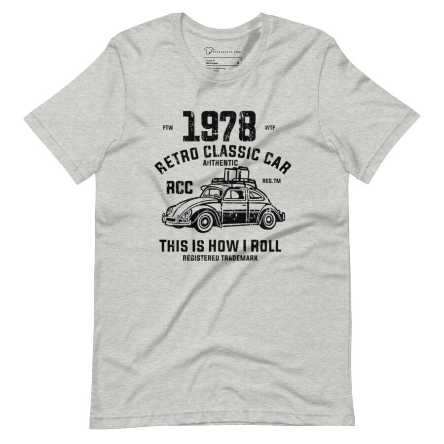 Gray unisex heavy cotton tee featuring a black graphic of a vintage Classic Car VW with text reading "1978 Retro Classic Car Authentic RCC Reg. TM. This is how I roll." Registered Trademark. Product name: Classic Car VW | I Roll | Unisex Heavy Cotton Tee.