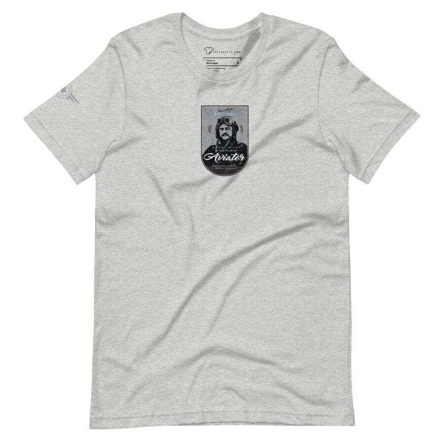 A light gray unisex T-shirt from St. Louise Aircraft, featuring the "Pioneer Aviator" graphic design on the front with an aviator wearing sunglasses and a helmet, accompanied by the text "Pioneer Aviator" below the image.