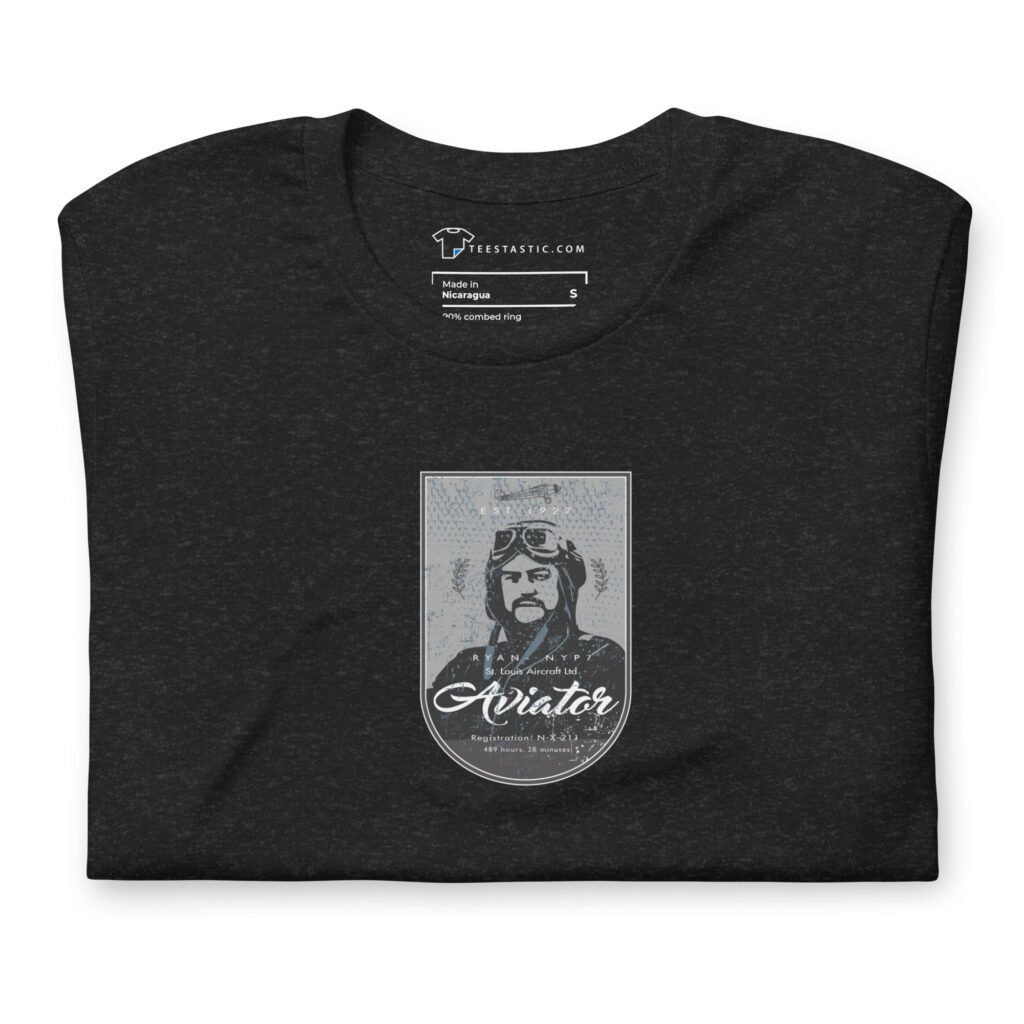 Presenting the "Pioneer Aviator | St. Louise Aircraft" unisex T-shirt in dark gray, size S. This cotton T-shirt features an illustration of a bearded pioneer aviator in goggles and a helmet, with the word "Aviator" written beneath the image to celebrate the spirit of St. Louise Aircraft.