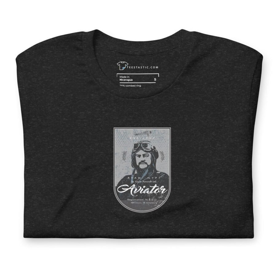 Presenting the "Pioneer Aviator | St. Louise Aircraft" unisex T-shirt in dark gray, size S. This cotton T-shirt features an illustration of a bearded pioneer aviator in goggles and a helmet, with the word "Aviator" written beneath the image to celebrate the spirit of St. Louise Aircraft.