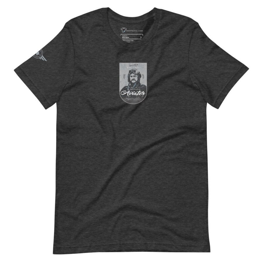 A unisex T-shirt in charcoal gray, featuring a graphic of a pioneer aviator with goggles and a helmet on the front, inspired by St. Louise Aircraft. The product is named "Pioneer Aviator | St. Louise Aircraft.