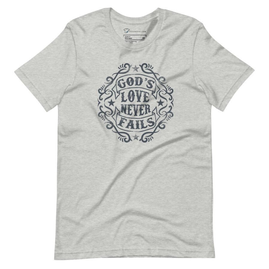 The GODS LOVE NEVER FAILS Unisex T-shirt showcases a light grey color with the motivational phrase "God's Love Never Fails" artistically displayed on the front.